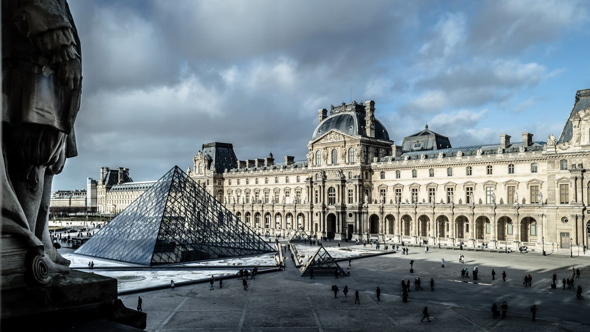 Paris. View on Louvre against gey clouded sky
